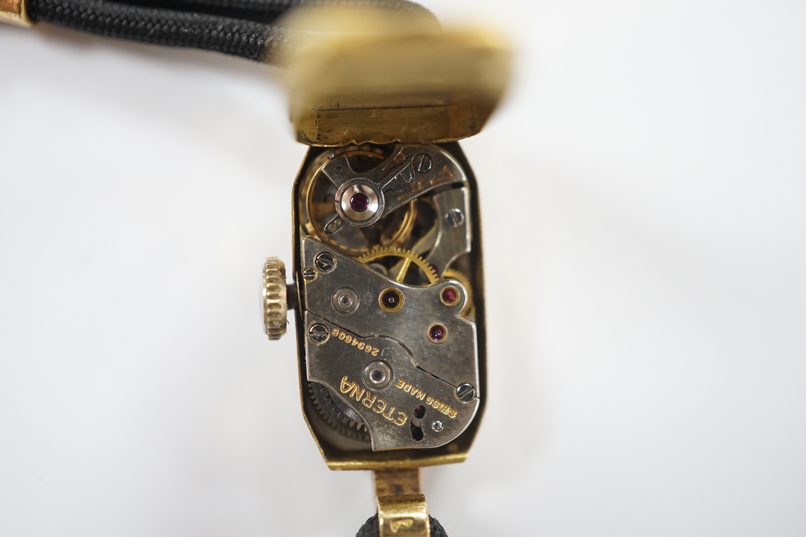 A lady's 1930's 18ct gold Eterna manual wind wrist watch, on a twin strand fabric strap with gold plated clasp